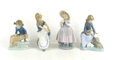 A group of four Lladro Nao porcelain figurines to include a young girl with doves, 15cm high, a