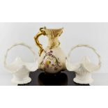 A Royal Worcester blush porcelain jug with gilt branch form handle, 19cm high, decorated with