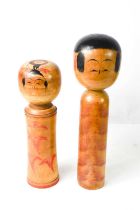 CHARITY LOT: Two Japanese wooden Kokeshi dolls, one signed to the base, 30cm high.