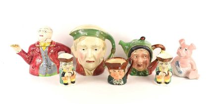 A group of character jugs and teapots to include examples by Royal Doulton, Beswick Ware and others,