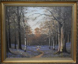 Gordon Allen (British 20th century): Two figures walking through bluebell woods, 39 by 50cm.