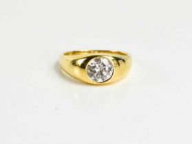 An 18ct gold and diamond solitare ring, the diamond approximately 1 1/4ct, in a rub over setting,