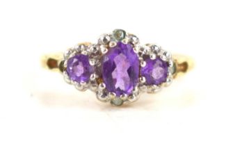 A 9ct gold and amethyst ring, the three oval graduated amethysts in platinum claw setting on