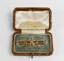 A 9ct gold Victorian brooch, the central cross set with seed pearls, along two bars, with the