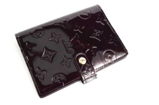 A Louis Vuitton patent leather deep burgundy wallet / purse, with button clasp.