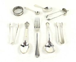 A group of silver to include a Georgian caddy spoon with shell shaped bowl, sugar tongs, King George