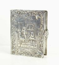 An early 20th century Dutch silver tobacco box of book form with clasp, the box embossed with