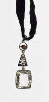 An Art Deco garnet and paste pendant on velvet choker, drop length 58.7mm.