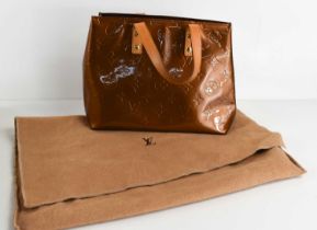 A Louis Vuitton copper coloured patent leather handbag, 25cm wide.