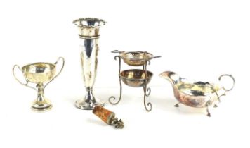 A group of silver to include a small silver trophy, sauce boat, tea strainer and a bud vase, 6.