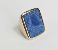 A large Sterling silver ring with a large blue stone, likely agate, carved with a floral pattern