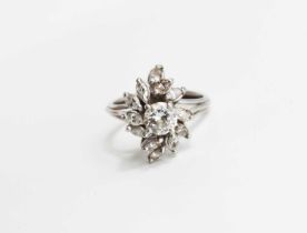 A vintage diamond dress ring, of flowerhead form, the central stone of approximately 0.7ct, 5.7mm