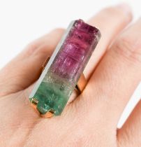 A 9ct gold and watermelon tourmaline cocktail dress ring, the large and impressive baguette cut