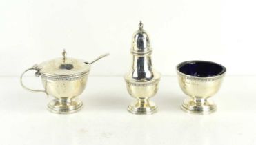 A silver cruet set comprising salt, pepper and mustard, with blue glass liners.