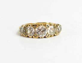 A gold and diamond five stone ring, the old cut diamonds graduated, with the central diamond