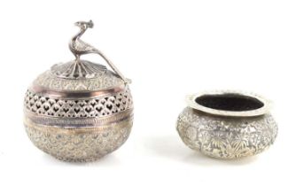 An Indian white metal jar and cover, the cover with peacock finial together a white metal bowl