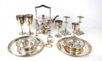 A group of silver plated items to include a kettle on stand, candlesticks. wine trays, goblet and