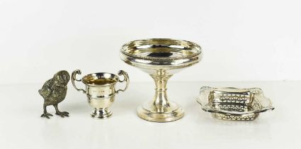 A silver bon bon dish with decorative pierced edge, small silver twin handled trophy, a silver