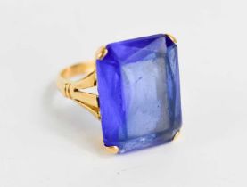 A 22ct gold and paste cocktail dress ring, set with large emerald cut deep cornflower blue paste