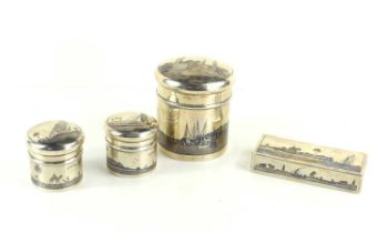 An Iraqi white metal and Nielo tea caddy together with two small jars and a tobacco box, decorated