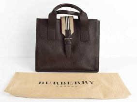 A Burberry dark brown leather tote handbag, with magnetic clasp, and the original dust bag.