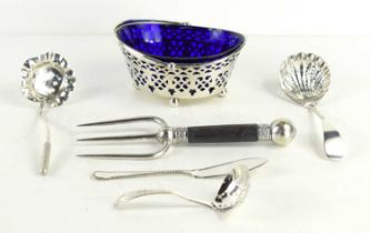 An antique silver basket with blue glass liner, the basket having pierced decoration and raised on