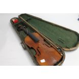 Students violin with bow in fitted case.