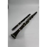 Picolo with nickel mounts and keys, 38cm long and a clarinet.