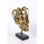 20th century bronze sculpture in the form of a skull wearing crown, titled 'Louis XIV', raised on