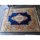 Prado Oriental Keshan carpet with floral decorated central medallion on blue field within foliate