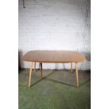 Ercol blonde tone five leg Grand Windsor model 444 extending dining table with additional folding