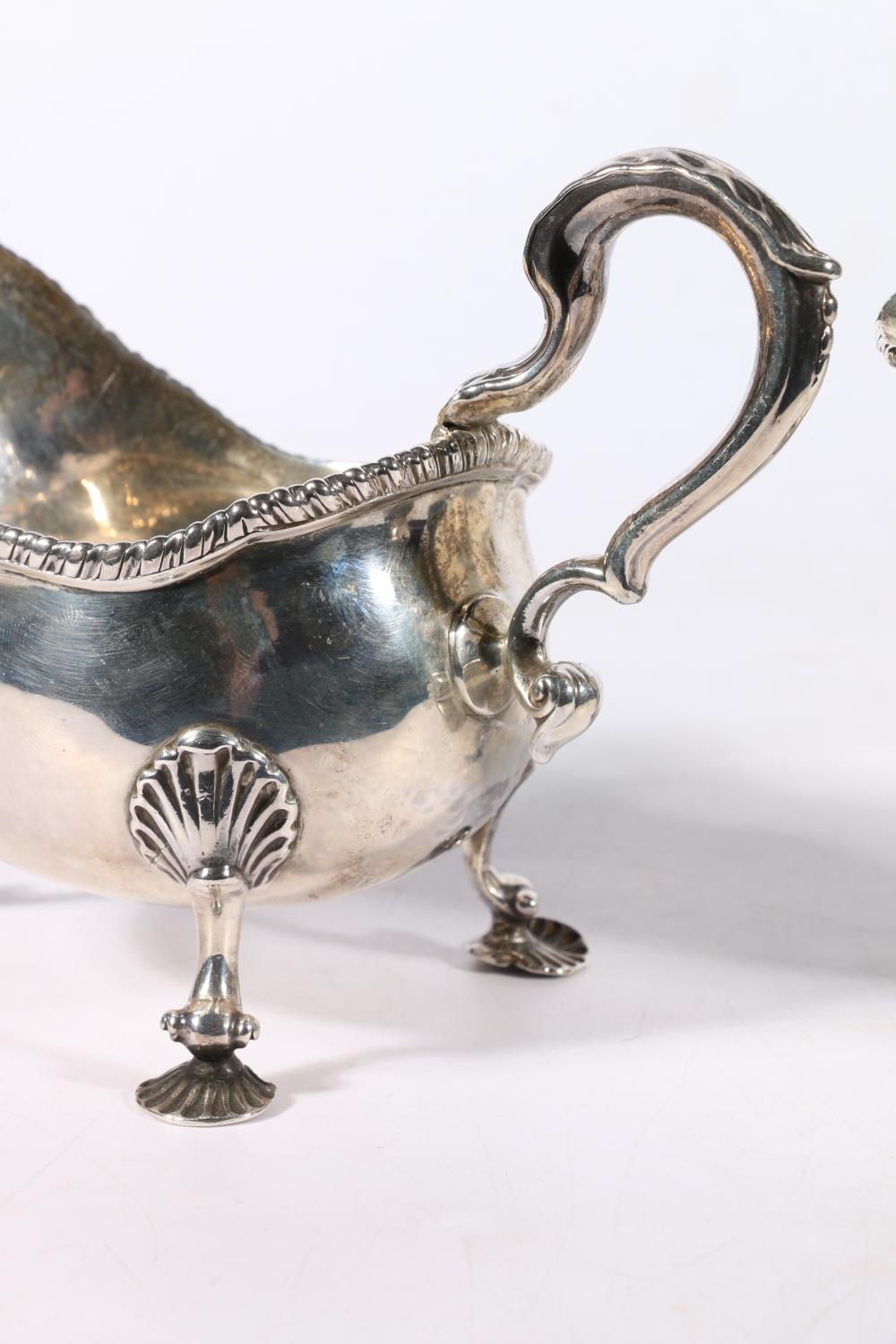 Pair of Georgian silver sauce boats with feathered edge and scroll handles raised on scallop shell - Image 2 of 4