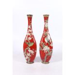 Pair of Japanese ginbari cloisonne slender vases, the red ground bodies decorated with birds and