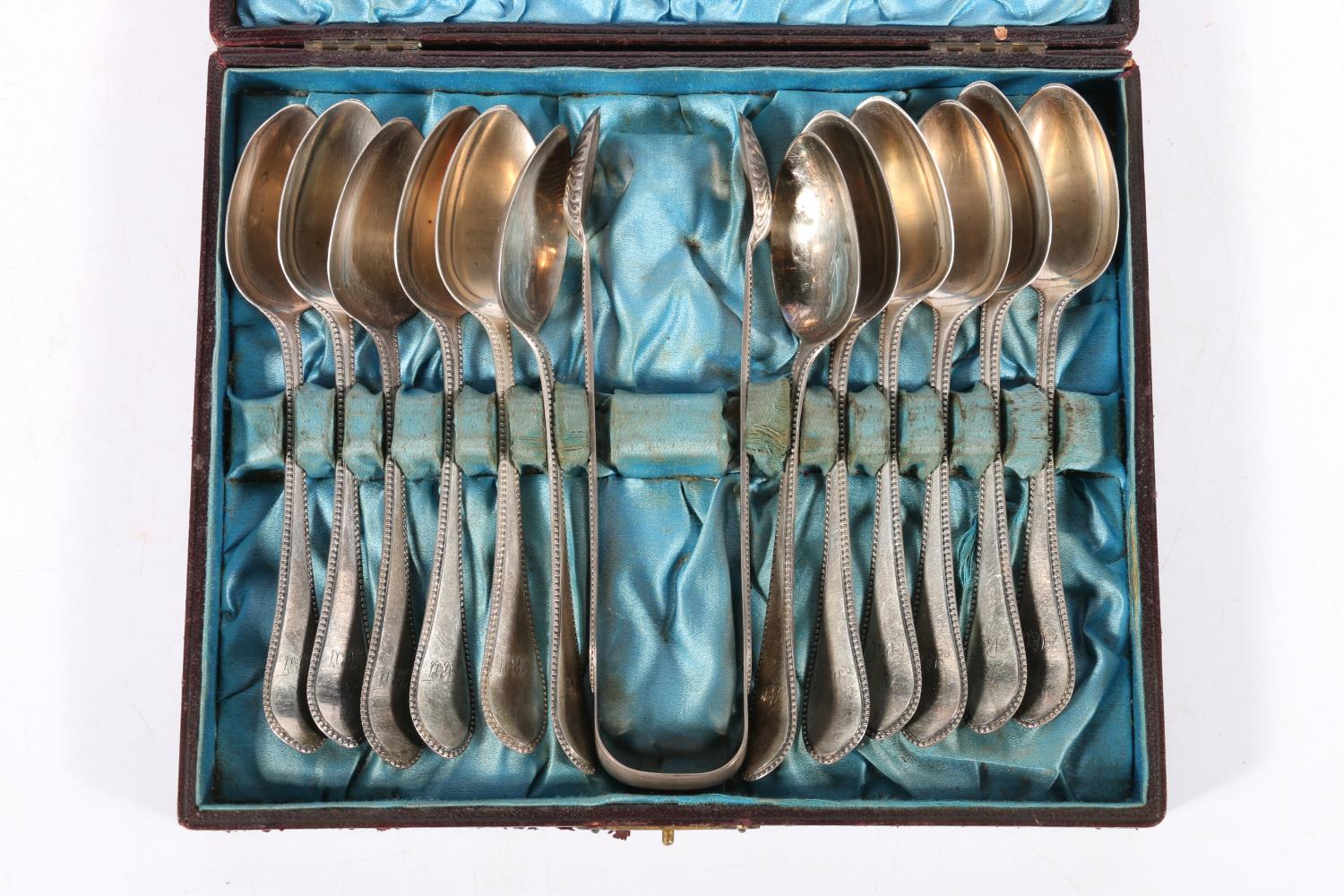 Set of twelve Victorian silver teaspoons with beaded edge and a matching set of sugar tongs,