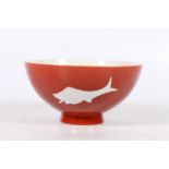 Chinese red ground bowl with fish decoration and six character mark to base, 16cm diameter.