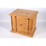 20th century pine nine-drawer specimen chest raised on plinth base with block feet, 38cm wide.