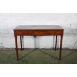 A Regency writing table with scroll inlaid top and cross banded edges over three frieze drawers