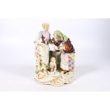 Antique German porcelain figure group modelled as a fortune teller palm reading a lady with a cherub