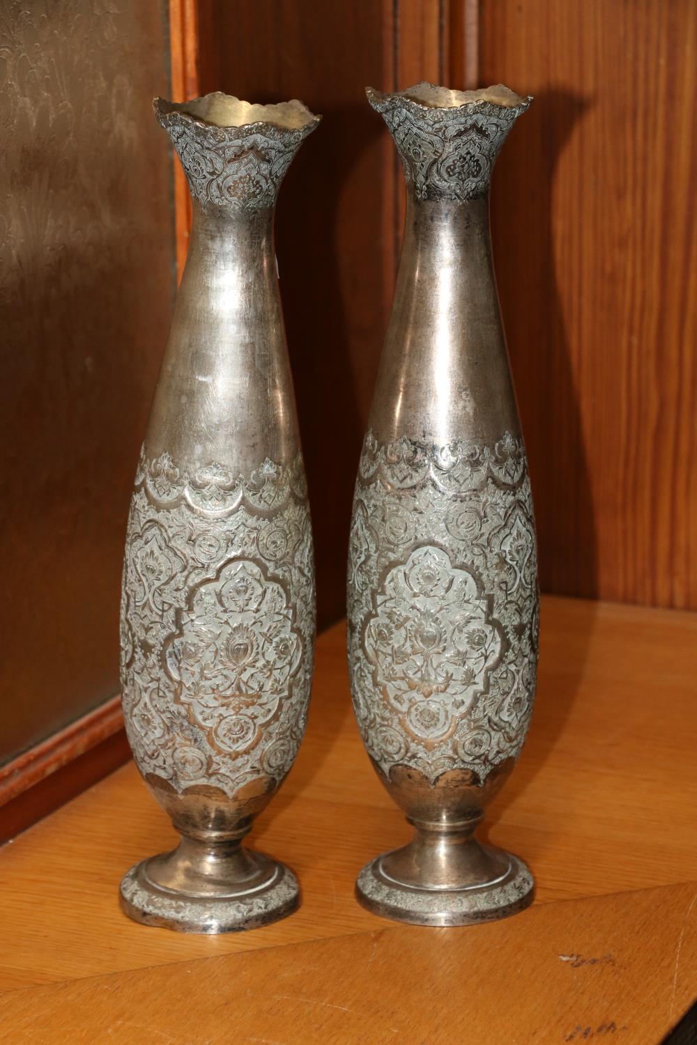 Pair of Indian white metal spill vases decorated with embossed floral designs, Arabic hallmarks,