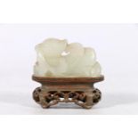 Chinese jade carving of a mythical creature, unsigned, 5cm long, raised on carved and pierced