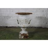 Cast metal garden urn with trumpet bowl, band of floral sprays to the body, twin handles, raised