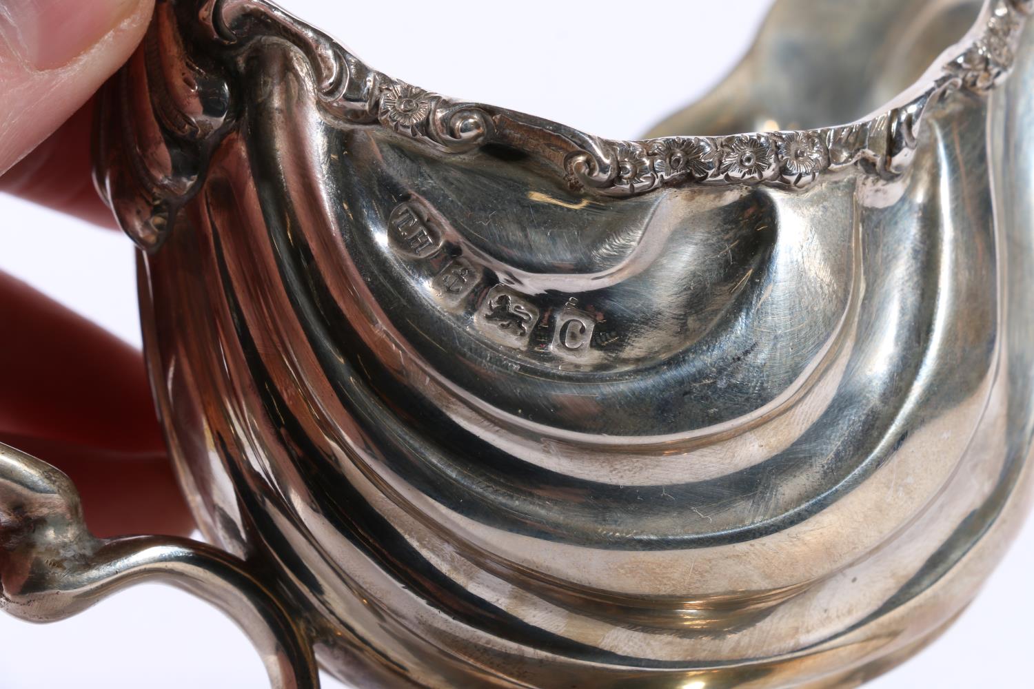 Edwardian silver cream jug with flower and scroll border and serpent handle raised on diamond shaped - Image 3 of 5