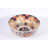 Large Oriental porcelain bowl decorated in the Imari palate, with designs of fish, dragon, and