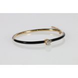 Gold and black enamel diamond set snap-shut bangle stamped Tiffany & Co, with safety chain, the