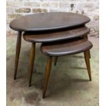 Set of three Ercol dark elm top pebble nesting tables, largest measures 40cm high.