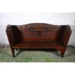 Scottish provincial carved oak settle having carved frieze, drop reading flap and raised on straight