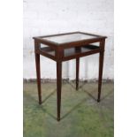 Antique carved mahogany bijouterie table raised on square tapering supports terminating in spade