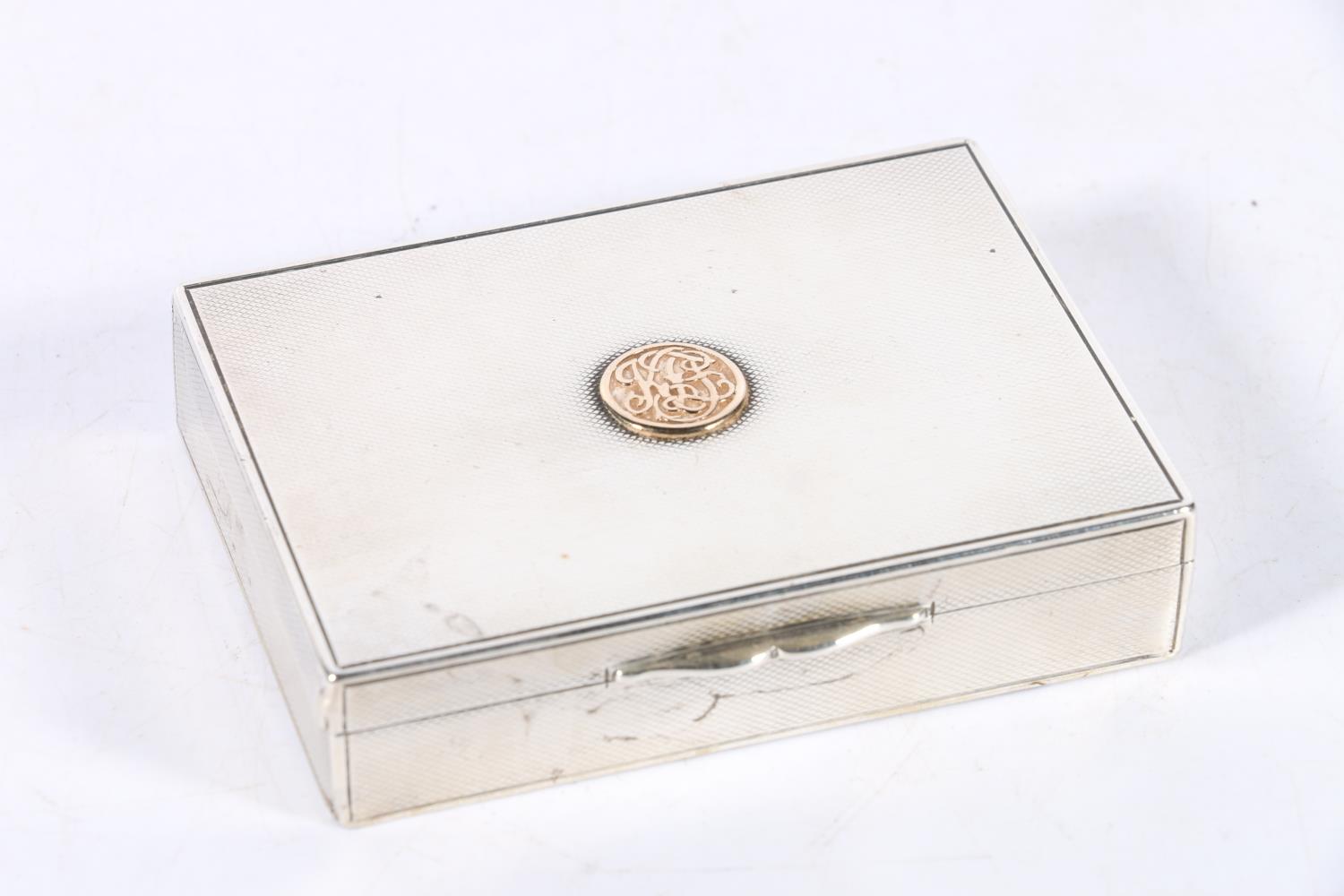 Edwardian silver cigarette box with engine turned decoration and applied crest by Frederick Thomas