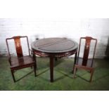 A Chinese hardwood circular extending dining table with two leaves, 46cm each, mother of pearl inlay