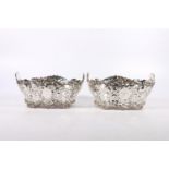 Two Victorian silver baskets with ornate relief and pierced work floral bodies, different makers